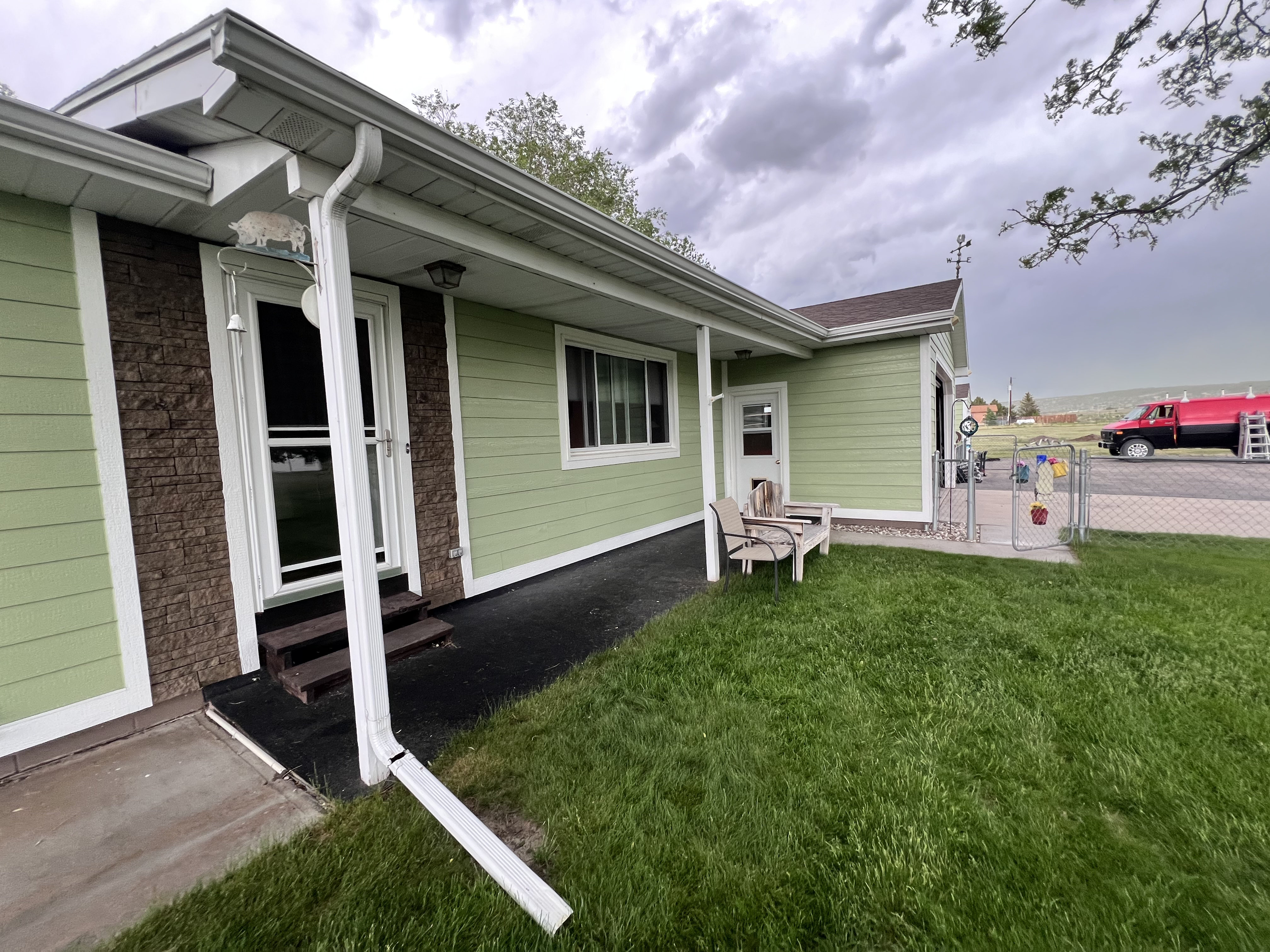 Completed green siding with stone accents in Newcastle, WY